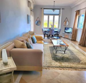 a living room with a couch and a table at The sea view in Douar el Hafey