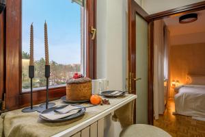 a room with a table with a cake and a window at Apartment Zagreb Spirit in Zagreb +5 photos