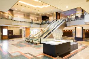 an escalator in a lobby with a slide at ANA Crowne Plaza Sapporo by IHG in Sapporo +137 photos