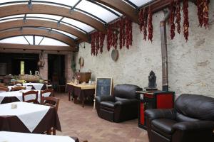 a dining room with tables and leather chairs and a room with tables and tablesktop at Fattoria Alvaneta in Padula