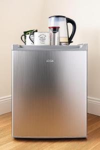 a coffee maker on top of a refrigerator at Central Guest Studio - En-Suite - Vibrant London in London