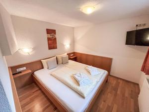 a bedroom with a bed with two pillows on it at Apartment Apart Edi by Interhome in Kappl +16 photos