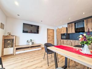 a kitchen and dining room with a table and chairs at Apartment Lindenthaler by Interhome in Aschau