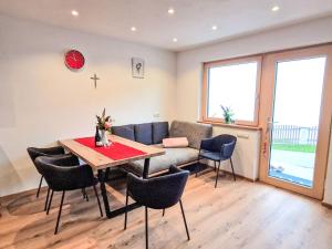a living room with a table and chairs and a couch at Apartment Lindenthaler by Interhome in Aschau +11 photos
