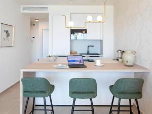 a kitchen with a desk with two chairs and a laptop at Apartment Bayviewhills Amazing Spa & Padel by Interhome in Torrox Costa +43 photos
