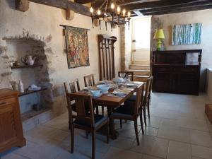 a dining room with a wooden table and chairs at Gite medieval St Jacques in Parthenay
