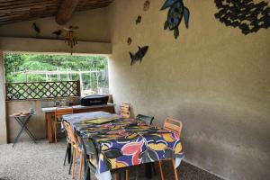 a dining room with a table and chairs with a table at Les Chambres du Luberon & Table d'hôtes in Lauris