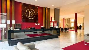 a lobby with a counter with a co sign on the wall at Dunamys Hotel Londrina in Londrina