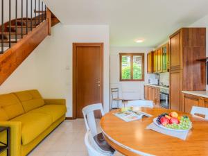 a kitchen and dining room with a table and a couch at Apartment Borgo Castello-5 by Interhome in Argegno +13 photos