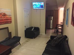 a living room with a couch and a tv on the wall at Mayflower Hospitality Hostel 2 in Washington, D.C.