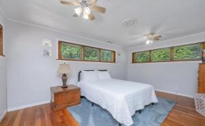 a bedroom with a bed and a ceiling fan at Cornerstone Cottage in Terre Haute