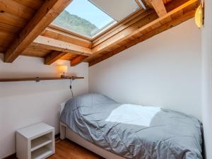 a bedroom with a bed and a skylight at Apartment Borgo Castello-3 by Interhome in Argegno