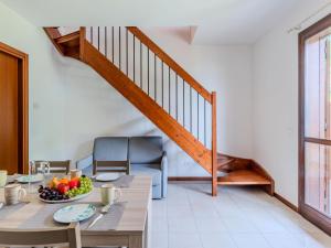 a dining room with a table and a staircase at Apartment Borgo Castello-3 by Interhome in Argegno