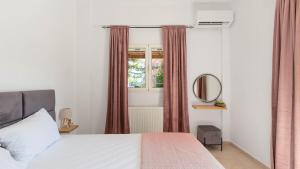 a bedroom with a bed and a window at Aura one in Lefkímmi