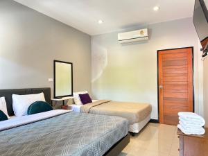 Ένα ή περισσότερα κρεβάτια σε δωμάτιο στο Saiinam Laguna Inn