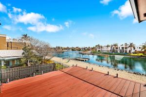 a view of a river with a wooden deck at The Waterville in Patterson Lakes