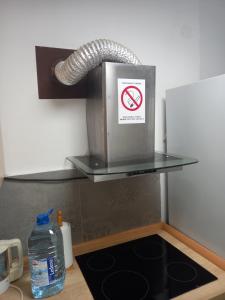 a kitchen counter with a sink with a no smoking sign at Apartman Lola Ruža in Zrenjanin +20 photos