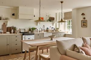 a kitchen and living room with a table and a couch at Stretton Hills Peaks - The Georgian House in Ludlow