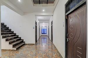 an empty hallway with stairs and a door at Hotel O ONCE MORE RESTAURANT AND CAFE in Prayagraj