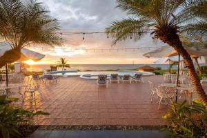 a resort patio with tables and chairs and the ocean at Gran Pacifica Beach & Golf Resort in San Diego