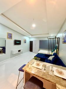 a living room with a blue couch and a table at Balcony Open Plan Studio Units -Lekki 1, WI-FI, one with balcony, the other without in Lagos +65 photos
