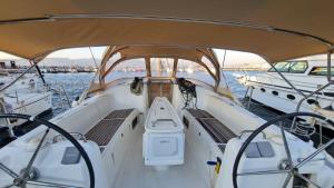 a white boat in a body of water at Nautical Nomads Yacht Charter in Tivat +1 photo