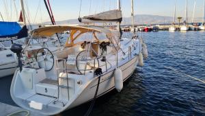 a white boat is docked in the water at Nautical Nomads Yacht Charter in Tivat