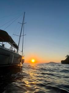 a sail boat in the water at sunset at Nautical Nomads Yacht Charter in Tivat