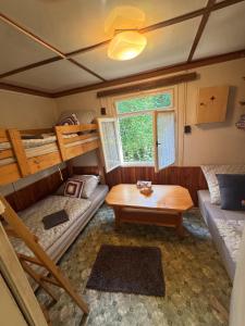 a room with two bunk beds and a table at Family fishing hut in Starý Petřín