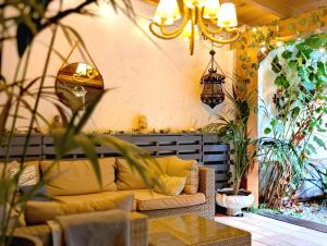 a living room with a couch on a patio at Portrait Boutique Guesthouse in Valencia +55 photos