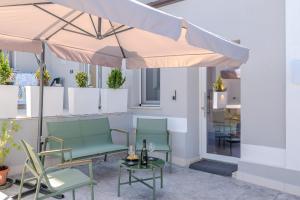 a patio with two chairs and an umbrella at Miramare Suites in Vasto