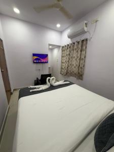 a large white bed in a room with a window at Hotel Udaan Villa in Hyderabad +1 photo