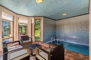 a home with a swimming pool and a living room at Bukovel Hotel in Bukovel
