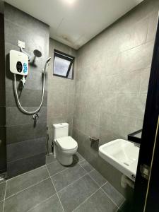 a bathroom with a toilet and a sink at Neu Suites Near KLCC in Kuala Lumpur