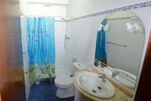 a bathroom with a sink and a toilet and a shower at Hostel Casal São João in Ribeira Brava +41 photos