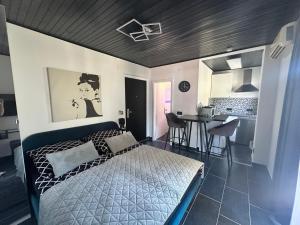 a bedroom with a bed and a kitchen with a table at Apartmani Vernissage in Biograd na Moru +117 photos
