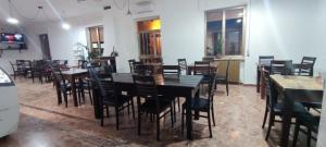 a dining room filled with tables and chairs at Sa Burra Guest House in Gadoni