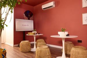a waiting room with two tables and stools at Serenity Room, Design House in Lagos