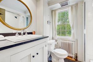 a bathroom with a sink and a toilet and a mirror at Kingdom Valley Farmhouse in Chester +44 photos