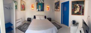 a bedroom with a bed and a blue door at Aigues Marines in Aigues-Mortes +22 photos