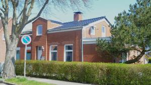 a red brick house with a chimney on top at blue lagoon in Fehmarn
