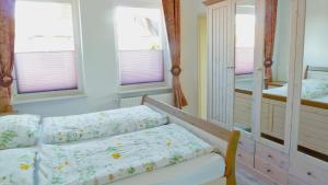 a bedroom with a bed and a mirror at blue lagoon in Fehmarn