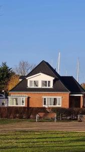 a house with a bench in front of it at Wohnung am Binnensee in Burgstaaken