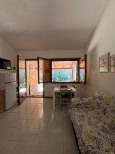 a living room with a couch and a table at La Casetta al mare in Stintino