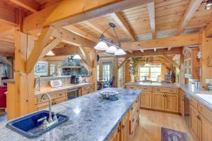 a large kitchen with wooden walls and wooden counters at Steps From Natl Forest Creekside Home in Durango in Durango
