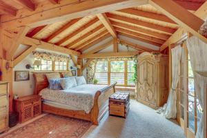 a bedroom with a bed in a room with wooden ceilings at Steps From Natl Forest Creekside Home in Durango in Durango