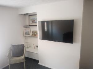 a living room with a flat screen tv on a wall at Number 28 with 1GB Fibre in Thetford
