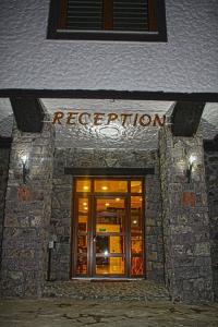 a building with the entrance to a redhibition at Hotel Ulpiana, Ethno House in Gracanica