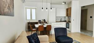 a living room and kitchen with a couch and chairs at ROYAL Residences in Cetinje