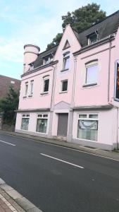 a pink building with a silo on the side of a street at Ferienwohnung Niesner Mitten in Sterkrade Oberhausen nah am Westfield Centro in Oberhausen